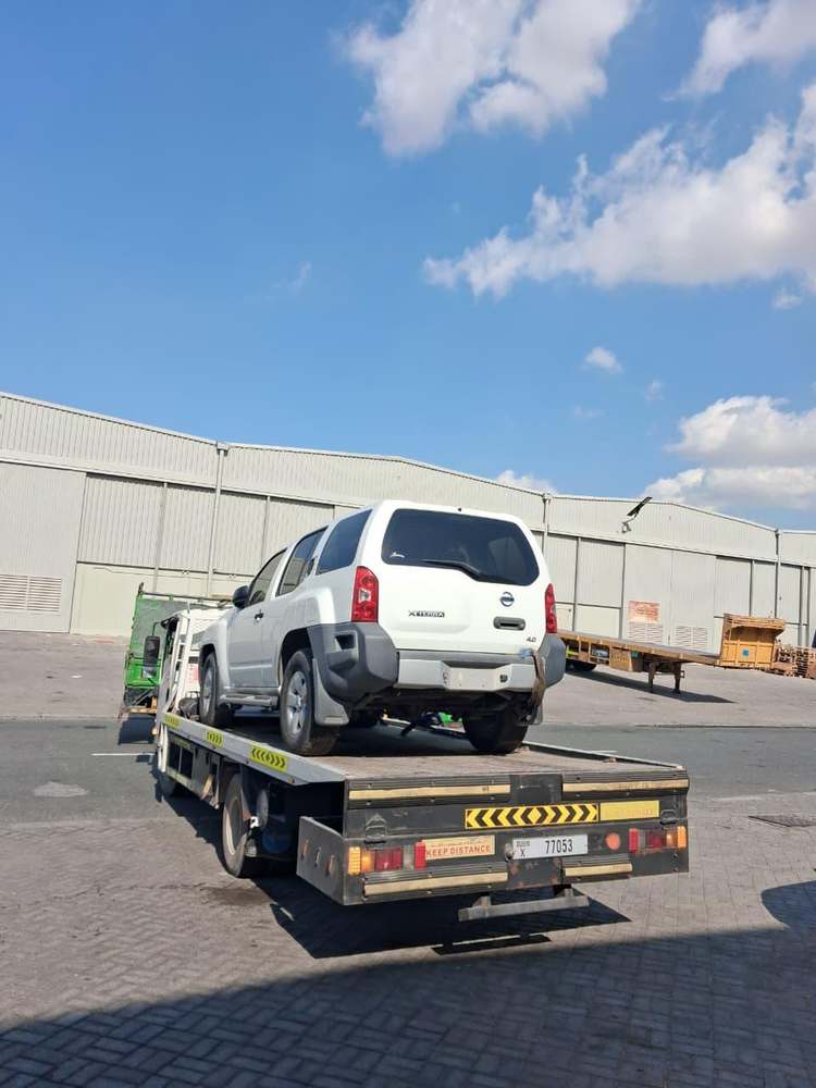 Nissan Xterra SUV secured on a recovery truck